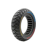 Pneu plein trottinette 10x2,75 tricolore vue 3/4 — bandes bleu jaune rouge, sculptures tout-terrain zigzag